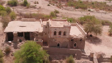 A-video-of-a-ruined-house-located-Chotiari-Dam-in-Sanghar-District,-Sindh,-Pakistan