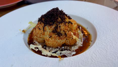 Fine-dining-truffle-cauliflower-in-a-michelin-restaurant,-luxury-fancy-food,-beautiful-presentation,-4K-shot