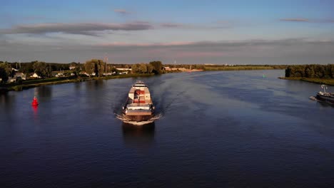 Aerial-View-Of-Forward-Bow-Of-FPS-Waal-Cargo-Container-Vessel-Approaching-River-Bend-On-Oude-Maas
