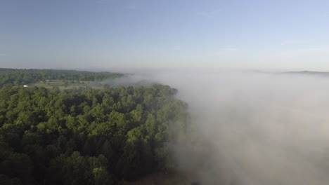 Slow-aerial-drone-shot-of-low-hanging-fog-over-a-forest-in-Oak-Hills,-West-Virginia