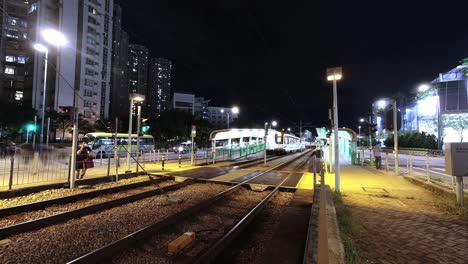 Busy-MTR-Light-Rail-with-many-night-time-travelers,-Tin-Shui-Wai,-time-lapse