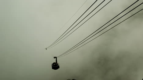 Iconic-Table-Mountain-cable-car-emerges-from-thick-cloud,-Cape-Town