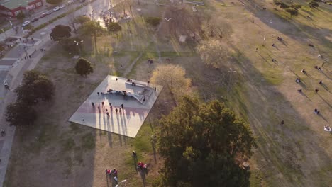 Aerial-drone-circling-view-of-people-relaxing-and-dancing-tango-outdoors-in-Buenos-Aires-park,-Argentina