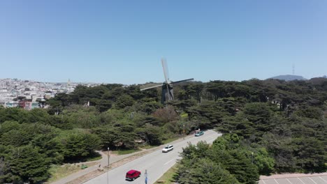 Low-push-in-aerial-shot-of-the-Dutch-Windmill-in-Golden-Gate-Park,-San-Francisco