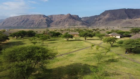 A-charming-little-African-village-surrounded-by-trees-and-the-amazing-mountains-of-Tanzania,-very-close-to-Lake-Natron-in-Africa