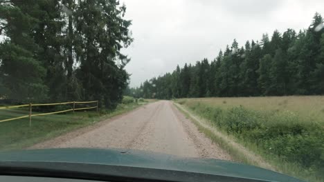 Driving-a-car-in-the-rain-on-a-dirt-road