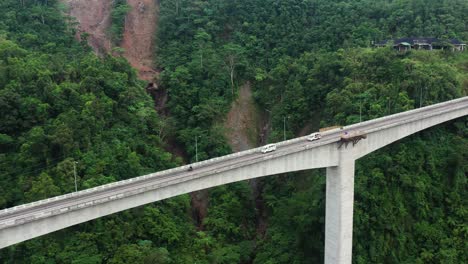 Vehicles-Driving-On-Agas-Agas-Bridge-In-Southern-Leyte,-The-Tallest-Bridge-In-The-Philippines---aerial-drone-shot