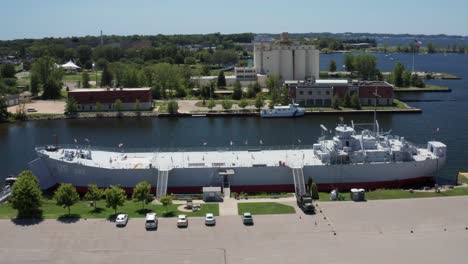 USS-LST-93-tank-landing-ship-in-Muskegon,-Michigan-with-drone-video-moving-in-and-down
