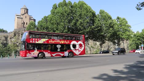 A-view-of-Red-Bus-doing-sightseeing-Tour-in-Tbilisi-City,-Georgia