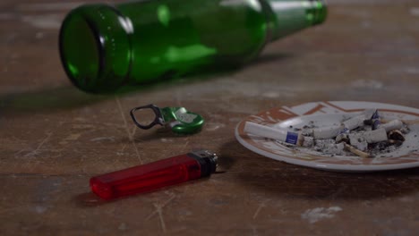 Table-with-beer-bottle-glass-and-ashtray-low-angle-slider-shot