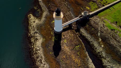 Aerial-top-down-orbit-shot-of-the-Tobermory-lighthouse-and-the-dramatic-Isle-of-Mull-coast