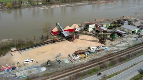 Container-Being-Loaded-With-Sand-On-Fraser-River-In-British-Columbia,-Canada
