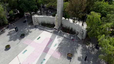 Kranschuss,-Der-Das-Denkmal-Für-Die-Mutter-Mit-Einem-Haufen-Wunderschöner-Grüner-Baumkronen-Und-Mehreren-Gebäuden-Dahinter-In-Mexiko-Stadt-Enthüllt