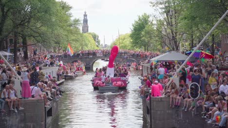 Lgbtq-Pride-Celebration-in-canals-of-Amsterdam,-Netherlands-with-thousands-of-supporters-gathered-around