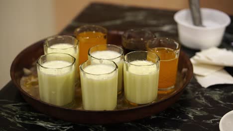 Close-up-shot-of-multiple-glasses-of-pineapple-and-mango-juice-served-with-carbonated-cola-drink