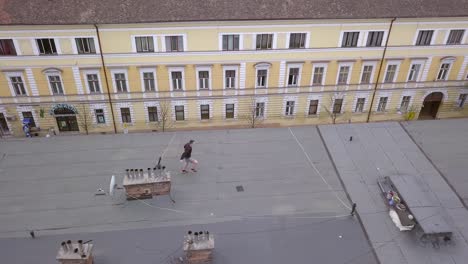 Epic-Shot-of-a-Young-Adult-Male-Parkour-Free-Runner-Running-and-Leaping-from-Rooftop-to-Roof-Top