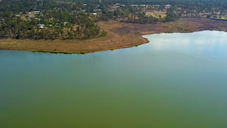 Drone-footage-moving-backwards-over-Lake-Dyer,-revealing-both-sides-of-the-lake