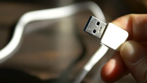 Close-up-macro-shot-of-a-standard-white-USB-cable-for-use-with-charging-a-smartphone-or-data-transfer