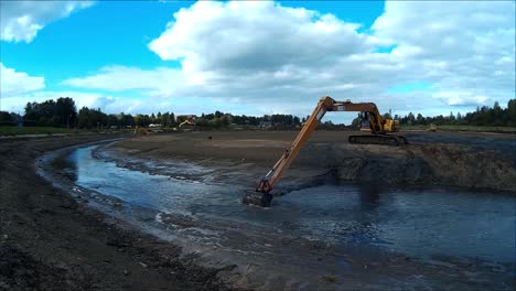 Excavators-are-working-with-Buckets-to-Clear-Mud-Sludge-and-Debris-from-the-Bottom-of-the-Drained-River
