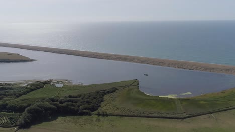 Aerial-tracking-forward-from-inland-towards-the-fleet-lagoon-at-Abbotsbury-in-Dorset