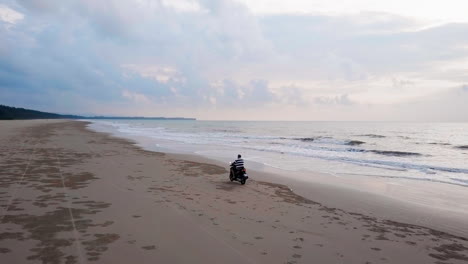 Drone-view-of-a-motorcycle-riding-on-the-beach-side