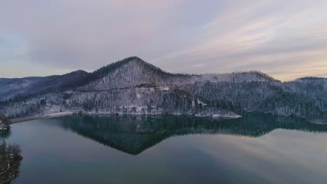 Aerial-view-of-calm-winter-lake-with-reflection-during-sunset