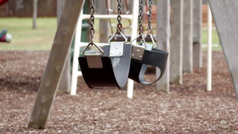 Empty-swing-set-in-an-empty-playground