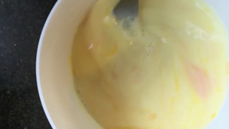 Stirring-EGGS-for-a-Breakfast-in-a-white-bowl
