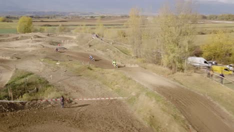 Aerial-shot-following-motocross-riders-on-race-track