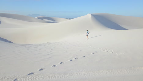 Aerial-of-man-hiking-on-sand-dunes-in-South-Africa