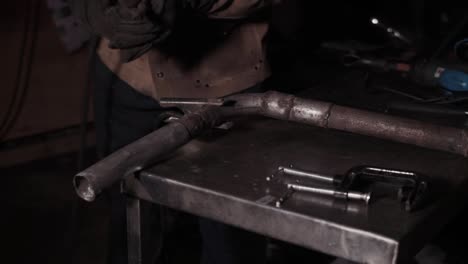 Experienced-welder-arc-welding-metal-in-garage-at-night