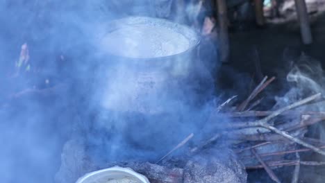 A-large-pot-of-food-cooks-on-a-typical-stove-fueled-by-sticks-in-a-rural-Asian-home