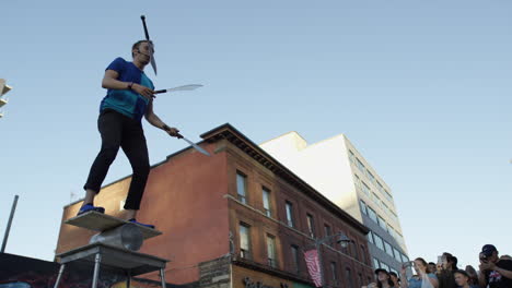 cinematic-man-juggling-swords-in-front-of-a-city-crowd