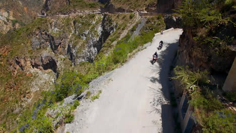 Aerial-Of-Motorcycle-Riders-Riding-Motorbike-On-Mountain-Roads