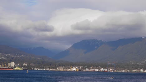 A-view-of-the-mountains-near-Vancouver-Downtown-with-a-boat-speeding-through-the-water