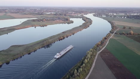 aerial-of-a-cargo-ship-on-a-river-transporting-raw-materials