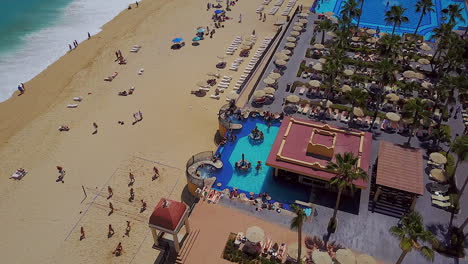 Drone-fly-over-of-a-resort-pool-and-beach-in-Cabo-San-Lucas-Mexico
