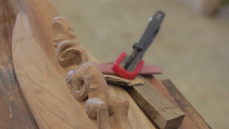 Closeup-in-slow-motion-of-wood-carving-a-Maori-element-in-a-woodshop