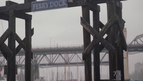 Ferry-dock-sign-on-wooden-construction-with-seagull-on-the-top