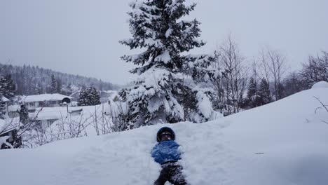 Young-man-is-falling-in-the-big-deep-pile-of-snow-for-fun-in-Norway