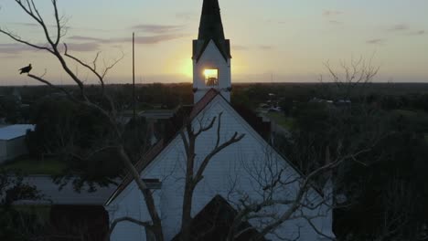 Small-church-with-steeple-and-approaching-sunrise