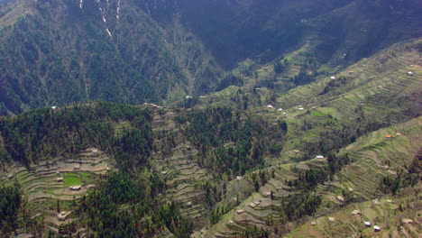 Making-close-up-aerial-view-of-the-houses-at-top-of-the-mountains-with-forest