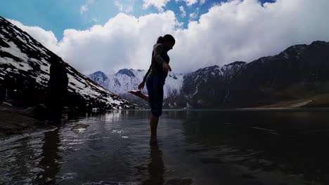 Young-woman-having-fun-at-a-cold-lake-in-the-mountains,-in-nevado-de-toluca-volcano-mexico