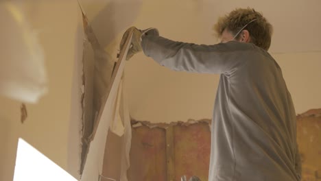 Pulling-down-old-plaster-board-in-house-SLOW-MOTION