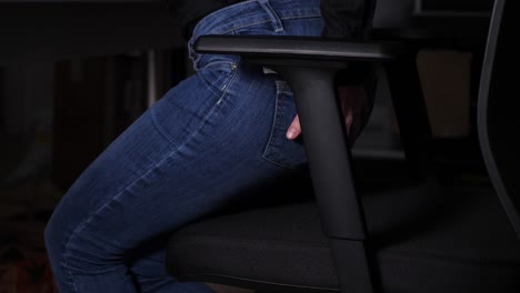Woman-wants-to-sit-on-a-chair-and-feels-sudden-anal-pain,-jumps-up-and-sits-slowly-again-having-hand-on-her-buttock