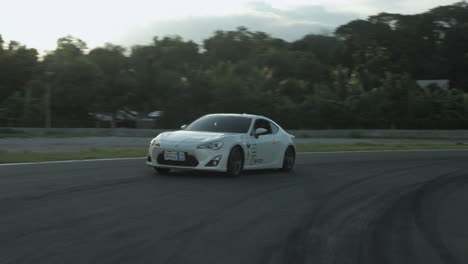 White-Race-Car-Drifting-and-Driving-Around-a-Motor-Sports-Track