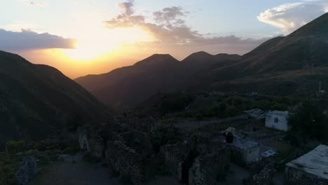 Aerial-shot-of-ruins-at-sunset-in-the-ghost-town-Real-de-Catorce-and-mountains,-San-Luis-Potosi-Mexico