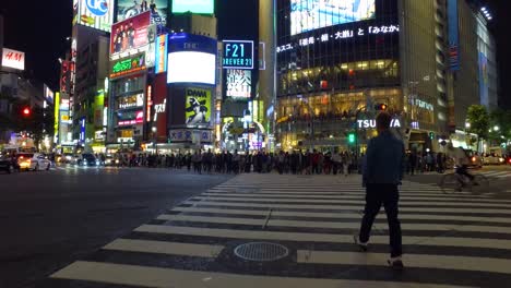POV-walking,-Thousands-of-people-walk-across-the-famous-Shibuya-Crossing-in-Tokyo-Japan