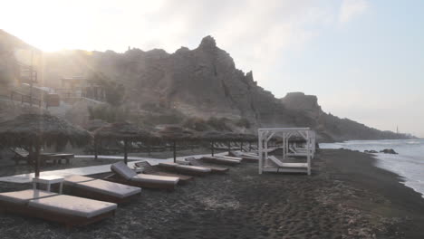 Empty-beach-club-in-the-early-morning-hours-at-the-black-beach-in-Santorini