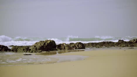 Nature-Sea-Ocean-Shore-Stones-Rocks-Waves-Big-Waves-Waves-Crash-Sand-Seaweed-Wind-Sunny-Daylight-Steady-Shot-Slow-Motion